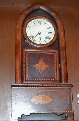 The antique wooden kitchen clock