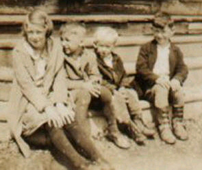  Biddie, Herbie, Josh (the toe head) and I sitting on the steps of the old abandoned store next to our apartment house on Upper Street. Herbie and I are the only ones left. 