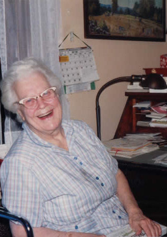 Aunt Lucy in her 90's with just a bit of God's Quiet Acre showing above her desk