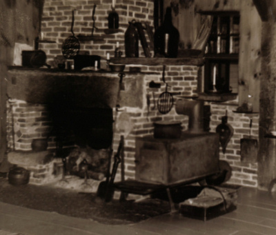 The large fireplace and schoolhouse stove in the Southwick Studio