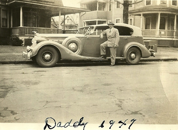 Arthur J. Bressor standing beside Robert Strong Woodwards Packard Phaeton 