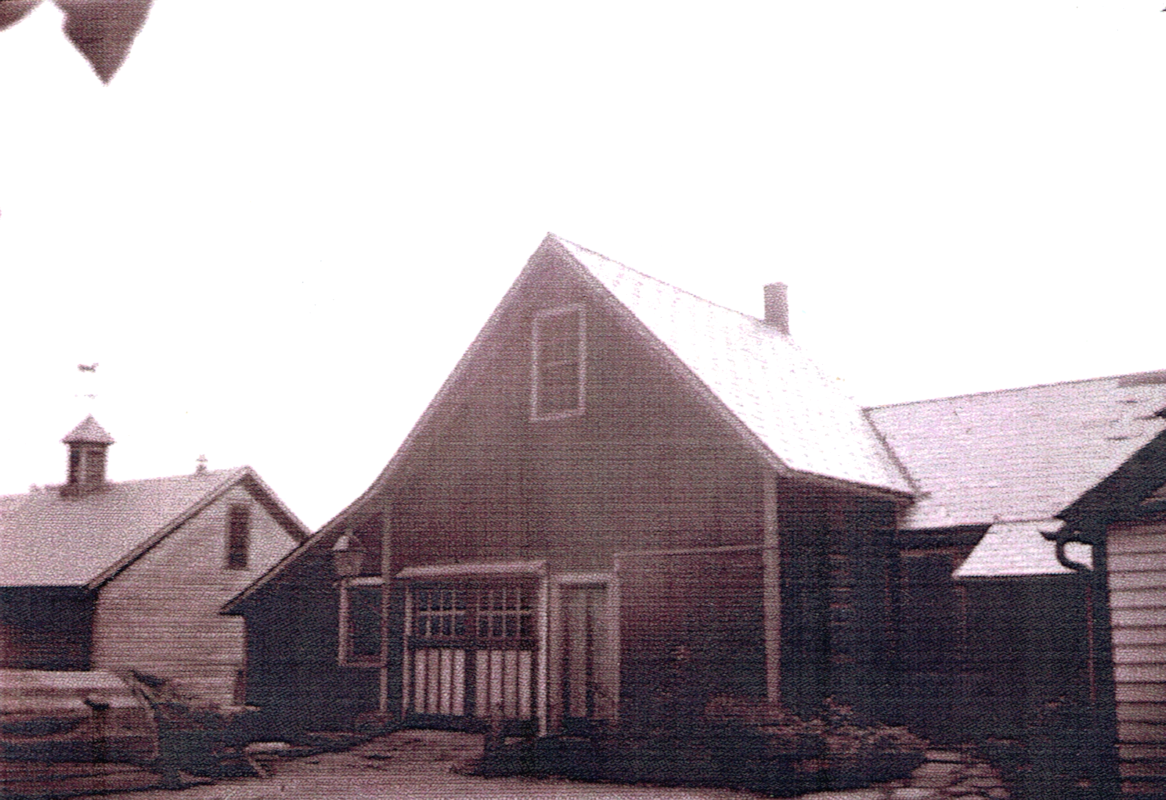 An old, grainy picture of the carriage house