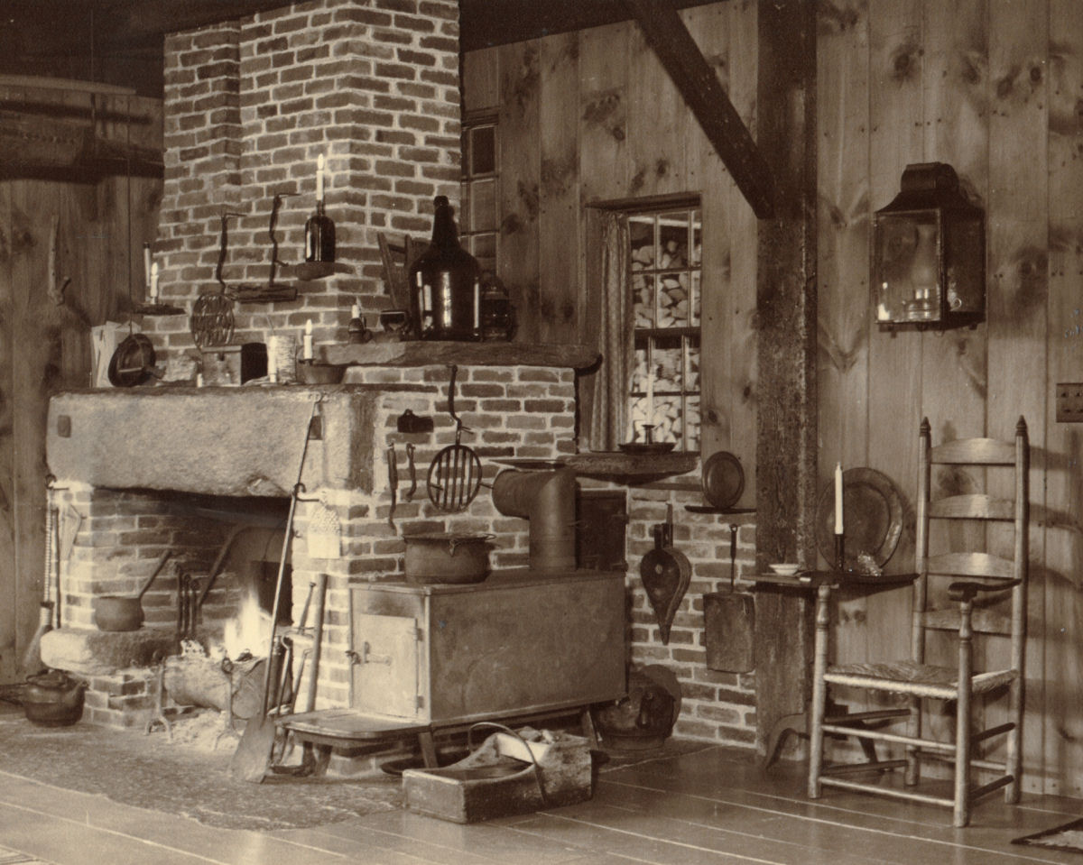 The fireplace in Southwick Studio that was built to replace the blacksmith's forge.  Note the schoolhouse woodstove on right used to heat the studio. <br/> The wood piled up outside the window was used in the kitchen stove in the house for cooking. 