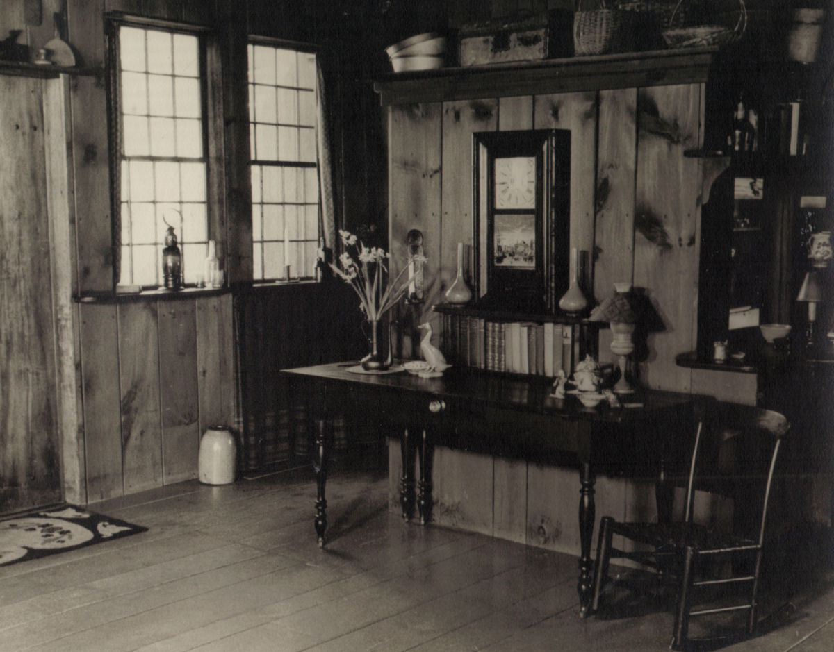 Entrance area of Southwick Studio showing old Boston seven-day weighted clock and cherry table. 