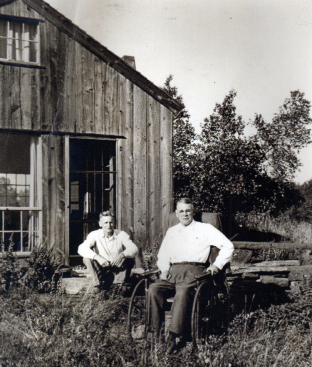 F. Earl Williams posing with Woodward in fornt of the Heath Pasture House